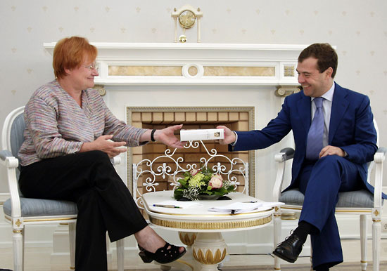 Russian President Dmitry Medvedev (right) presents a book to Finnish President Tarja Halonen during informal talks in Sochi on August 11, 2009.