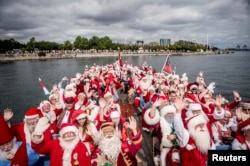People dressed as Santa Claus take part in the World Santa Claus Congress, an annual event held every summer in Copenhagen, Denmark, July 23, 2018. (Ritzau Scanpix/Mads Claus Rasmussen)