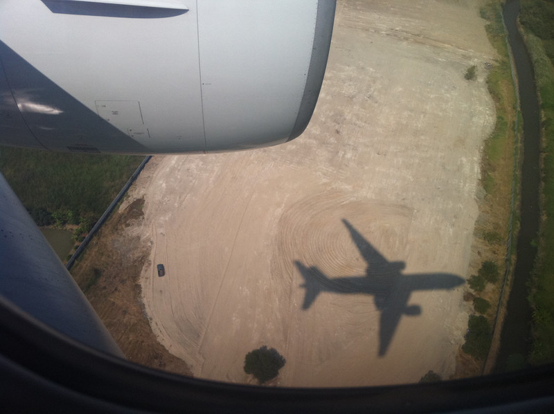 The shadow of a jumbo jet coming in to land at Bangkok Airport