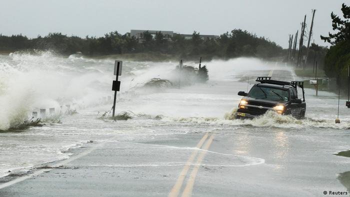 A truck drives through water pushed over a road by hurricane Sandy in Southampton, New York
(Photo: REUTERS/Lucas Jackson)